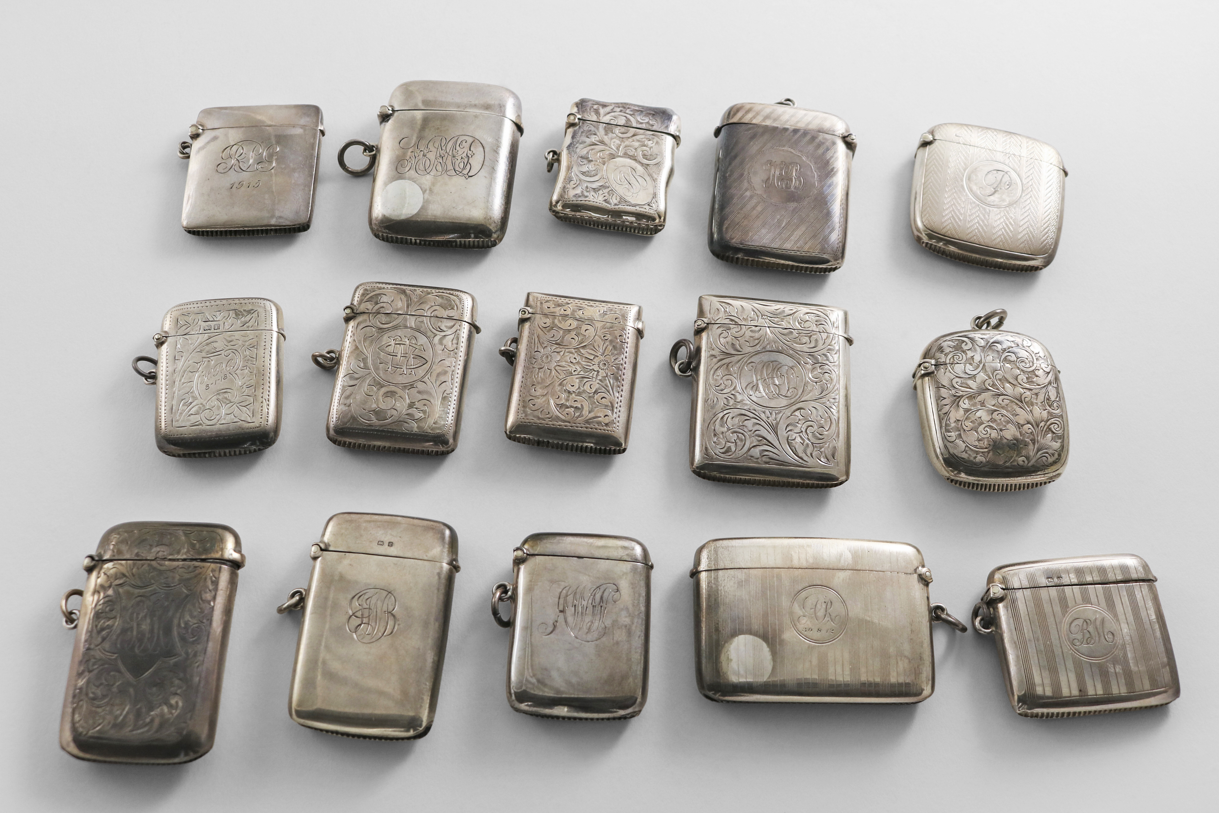 FIFTEEN VARIOUS EARLY 20TH CENTURY SILVER VESTA CASES all with initials, by various makers,