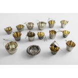 FOUR EARLY 20TH CENTURY FRENCH & ELEVEN SOVIET TEA STRAINERS (mostly pail-shaped, with a clip for