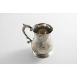 A LATE 18TH CENTURY CHANNEL ISLES MUG of baluster form with a scroll handle and a spreading circular