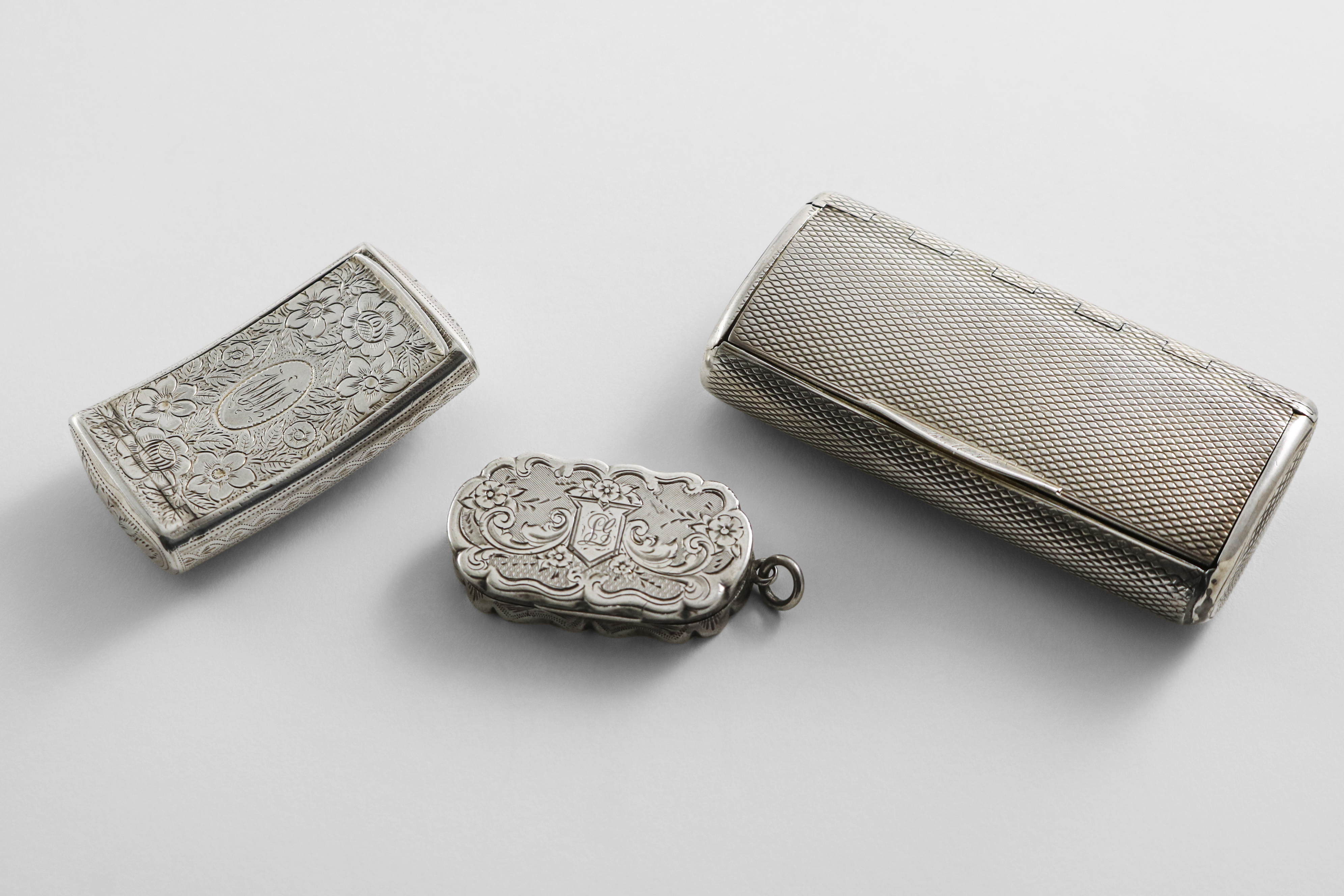 A GEORGE III SILVER ENGINE-TURNED SNUFF BOX of rounded oblong form with a concealed hinge, by A.J.