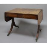 REGENCY MAHOGANY AND CROSSBANDED SOFA TABLE, the canted rectangular top above two drawers, a high