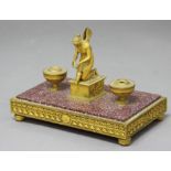 FRENCH EMPIRE ORMOLU AND PORPHYRY DESK STAND, the central figure of a nymph kneeling on the cover to