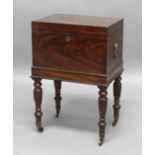 GEORGE III MAHOGANY CELLARETTE, of rectangular form, with a fitted interior and on foliate carved