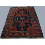 KAZAK RUG, Central Caucasus, circa 1910, the deep indigo field centred by an indigo and terracotta