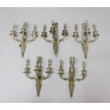 SET OF FIVE GILT METAL TRIPLE BRANCH WALL LIGHTS, with ribbon crests and scrolling arms, height 36cm