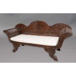 ANGLO INDIAN HARDWOOD SETTEE, 19th century, the arched back with floral decoration above scroll arms