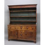 GEORGE III OAK DRESSER, possibly North Wales, the three shelf plate rack on a base with a T