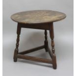 OAK CRICKET TABLE, 18th century, the circular top on turned and block supports, height 63cm, width