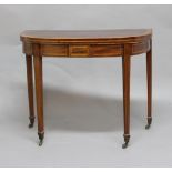 MAHOGANY AND CROSSBANDED FOLD OUT CARD TABLE, the bow front top on tapering square section legs,