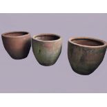 SET OF THREE LARGE TERRACOTTA PLANTERS, of rounded form with line decoration to the rim, height