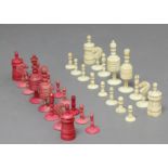 ENGLISH TURNED BONE CHESS SET, late 19th century, in the barleycorn pattern, red stained and