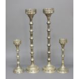TWO PAIRS OF SILVERED PRICKET CANDLE STICKS, the pierced rims above knopped stems and stepped