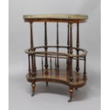 VICTORIAN WALNUT AND INLAID KIDNEY SHAPED CANTERBURY WHATNOT, with gilt brass gallery and mounts