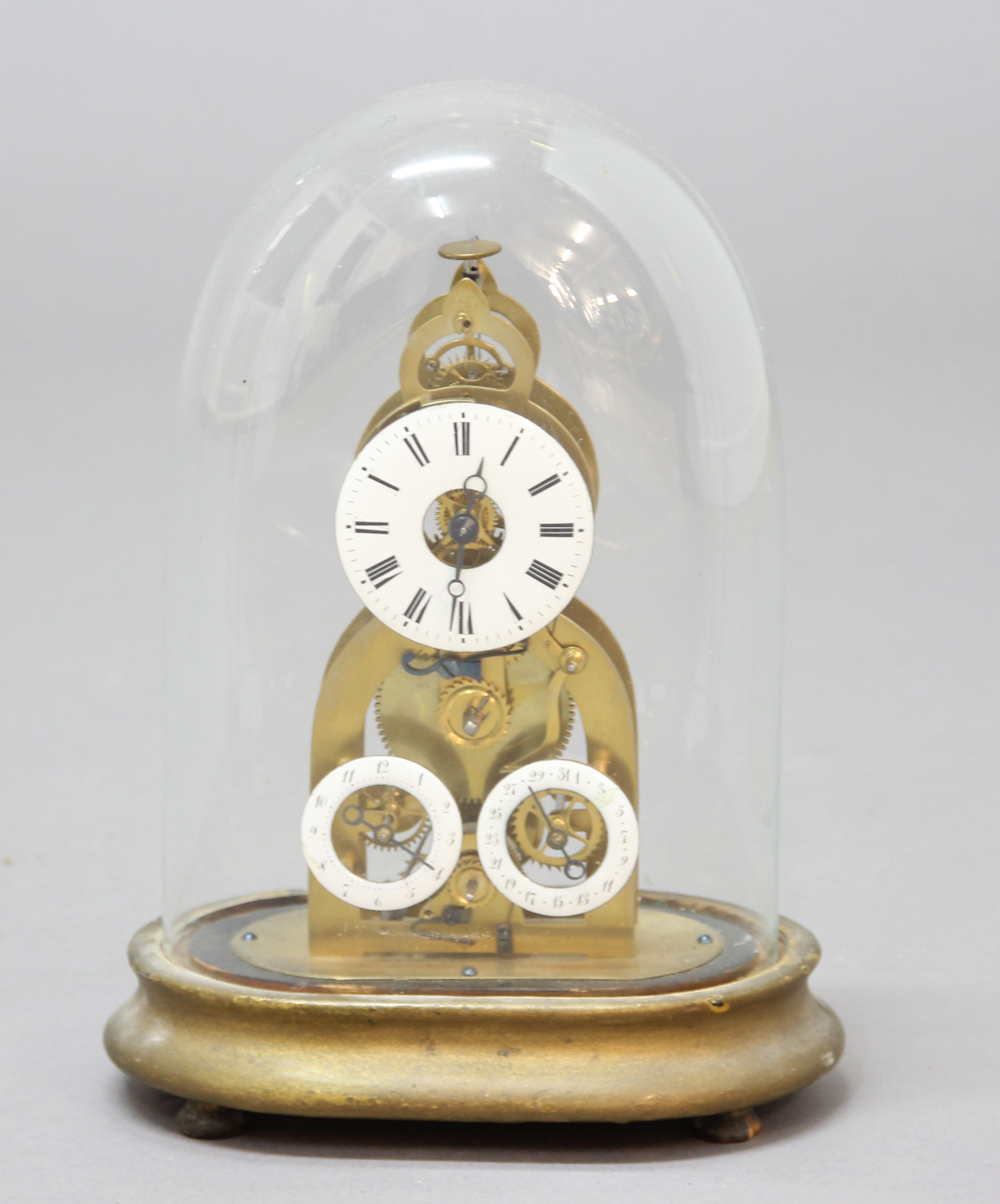 FRENCH BRASS SKELETON TIMEPIECE, the 2 1/2" enamelled dial above subsidiary alarm and date dials