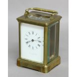 FRENCH BRASS FOUR PANE CARRIAGE TIME PIECE, 19th century, the enamelled dial inscribed Swinden &