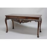 GEORGE II STYLE IRISH MAHOGANY SERVING TABLE, the rectangular top above a frieze centred on a lion