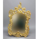 FRENCH GILTWOOD WALL MIRROR, the shaped plate in a pierced, scrolling frame, height 128cm, width