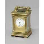 CASED MINIATURE BRASS CARRIAGE TIME PIECE, the enamelled dial inside an engine turned frame, the