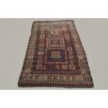 KAZAK RUG, Central Caucasus, circa 1900, the madder field with three panels containing hooked