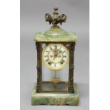 BRASS AND GREEN ONYX FOUR GLASS MANTEL CLOCK, the 3 3/4" ivorine dial with a visible Brocot type