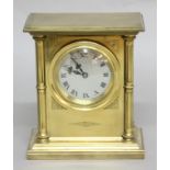 BRASS CASED MANTEL CLOCK, the 2 1/2" silvered dial with Roman numerals, the case with column corners