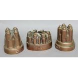 TWO COPPER JELLY MOULDS, stamped Barrow & Wilson, Strand; together with a third mould stamped 'J.W',