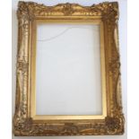 A VICTORIAN PICTURE FRAME with foliate sight and latticed hollow, leafy floral scrolled centres