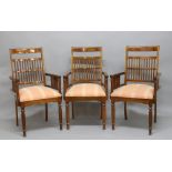 SET OF FOUR INDIAN ROSEWOOD ELBOW CHAIRS, in the Colonial style, the bar and spindle backs above