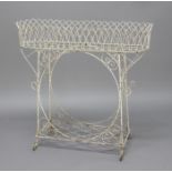 REGENCY STYLE WIRE WORK JARDINIERE, of rounded rectangular form on a scrolling frame, height 83cm,