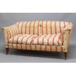 HOWARD AND SONS SOFA, the arched back above slightly scrolled arms, paper label to the frame,