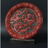 CHINESE CINNABAR LACQUER DISH, late 19th or 20th century, three scrolling dragons on a wave or cloud