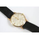 A GENTLEMAN'S GOLD WRISTWATCH BY LONGINES the signed circular dial with baton numerals and