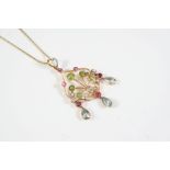 A GOLD AND GEM SET PENDANT the gold openwork design is set with circular-cut peridots, rubies and