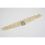 AN EDWARDIAN NATURAL SEED PEARL CHOKER the openwork seed pearl choker is set to a diamond and