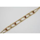 A GOLD, RUBY AND DIAMOND BRACELET BY REPOSSI the 18ct gold double row chain bracelet is mounted with