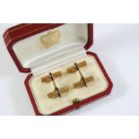 A PAIR OF 18CT GOLD AND SAPPHIRE CUFFLINKS BY CARTIER each striated gold baton is circled by a