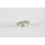 A DIAMOND FIVE STONE RING the five brilliant-cut diamonds are set in platinum. Size L 1/2