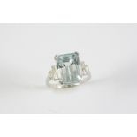AN AQUAMARINE AND DIAMOND RING the step-cut aquamarine is set with three baguette-cut diamonds to