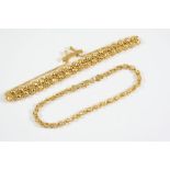 A 9CT GOLD FANCY LINK BRACELET formed with two rows of hexagonal balls each surrounded by gold