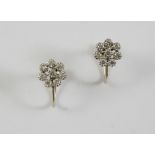 A PAIR OF DIAMOND CLUSTER EARRINGS of flowerhead form, each set with circular-cut diamonds in