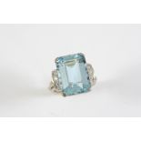 AN AQUAMARINE AND DIAMOND RING the step-cut aquamarine is set with five circular-cut diamonds to