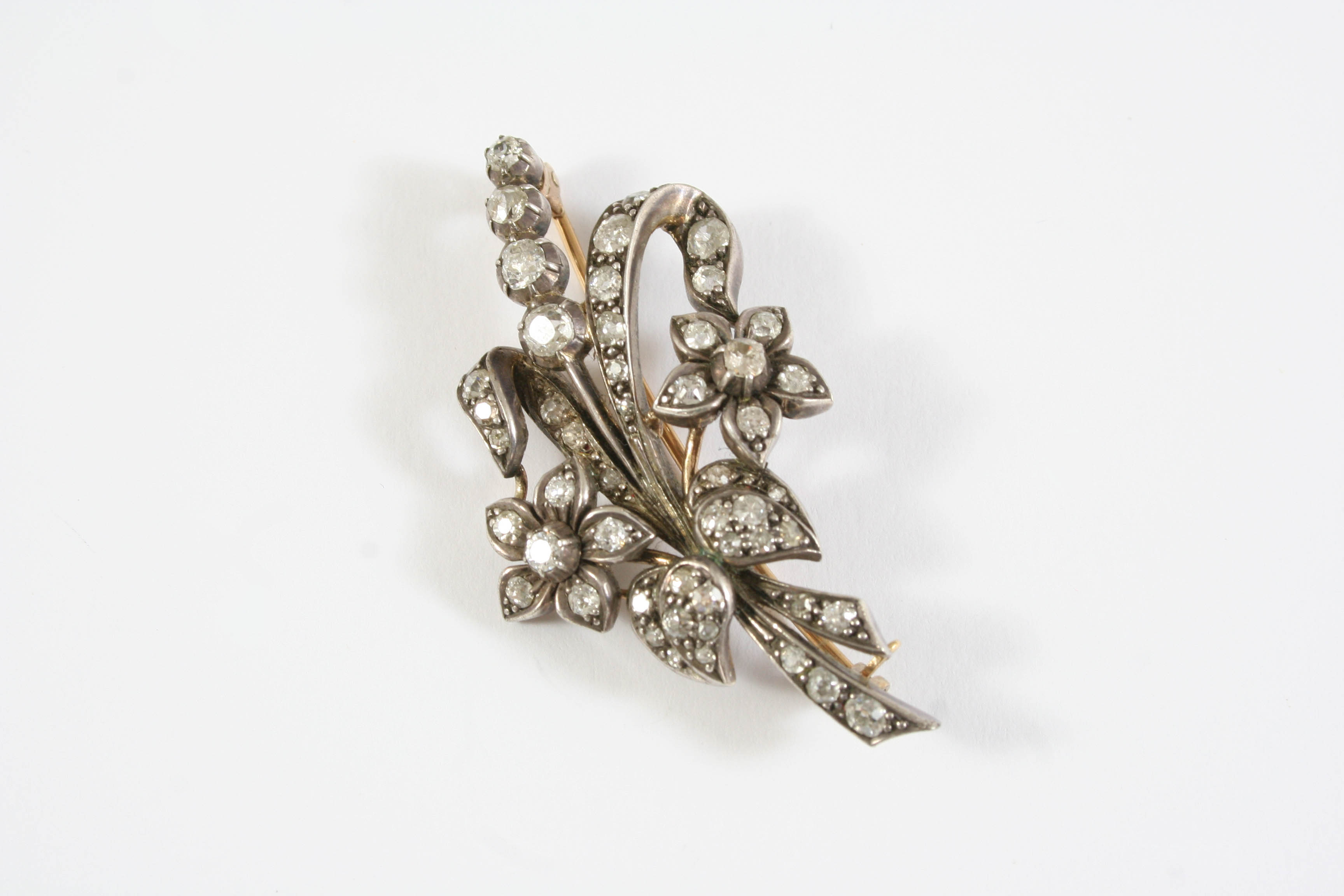 A VICTORIAN DIAMOND SPRAY BROOCH set overall with graduated old circular-cut diamonds, in silver and