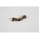 AN ENAMEL AND DIAMOND BROOCH the royal blue guilloche enamel scroll is set in gold and mounted