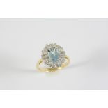 AN AQUAMARINE AND DIAMOND CLUSTER RING the oval-shaped aquamarine is set with two baguette-cut and