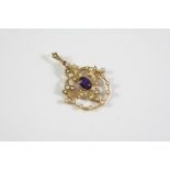 AN EDWARDIAN AMETHYST AND PEARL SET PENDANT the 15ct gold openwork mount is centred with an oval-