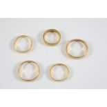 THREE 22CT GOLD WEDDING BANDS 8.6 grams, together with two unmarked gold wedding bands, 6.6 grams