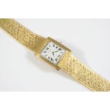 A GENTLEMAN'S 18CT GOLD WRISTWATCH BY CARTIER the signed rectangular dial with Roman numerals, on an