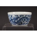 CHINESE BLUE AND WHITE TEA BOWL, blue painted with a scrolling dragon amongst foliage, Qianlong