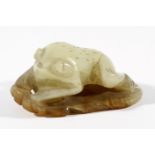 CHINESE CELADON AND RUSSET JADE FROG, seated on a lily leaf, length 6cm