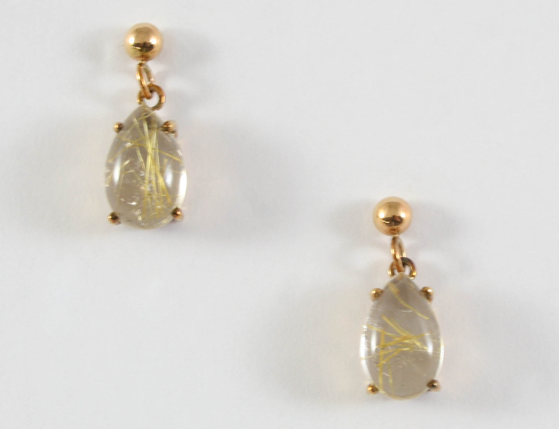 A PAIR OF RUTILATED QUARTZ DROP EARRINGS each earring set with a pear-shaped quartz drop, in